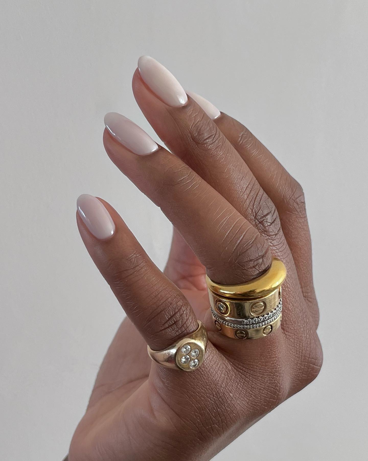 An image of @paintedbyjools wearing BIAB nails.