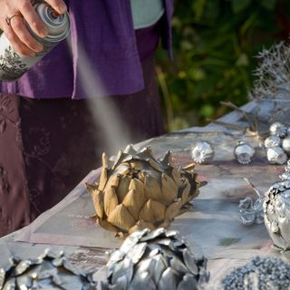 spray painting dried seedheads with silver paint