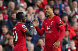 Liverpool’s Sadio Mane (left) celebrates with Virgil van Dijk after scoring their side’s first goal of the game during the Premier League match at Anfield, Liverpool. Picture date: Sunday October 3, 2021