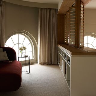 room with white curtains flower in vase and semiarched window