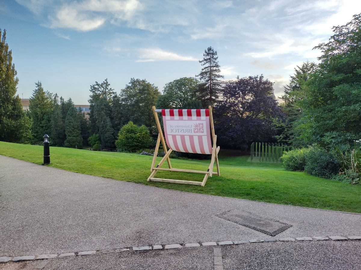 A photo of a lawn chair overlooking some trees