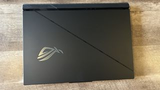 Asus ROG Strix Scar 18 lid closed on a wooden table