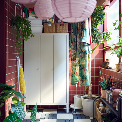 KOLBJ&Ouml;RN Cabinet in a conservatory with red tiles.