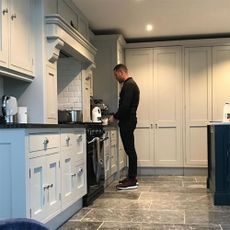kitchen room with grey tiled flooring and kitchen cabinets