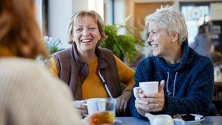 Sober October - women smiling and laughing together over coffee