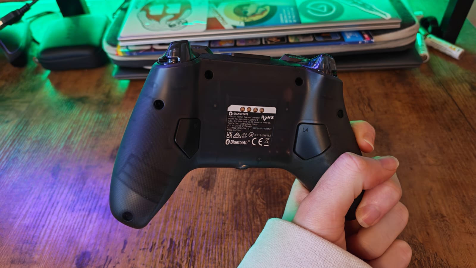 A reviewer showing the back of the GameSir Cyclone 2