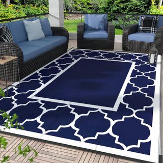 navy and white patterned rug in the middle of an outdoor seating area