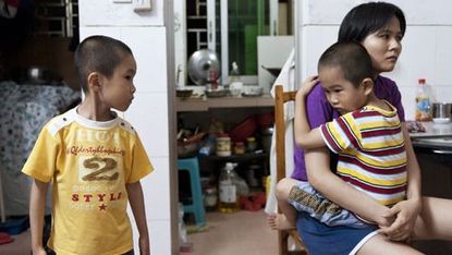 a chinese woman with her two children