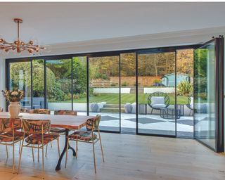 Slide and turn doors in a dining area with view of outdoor garden area