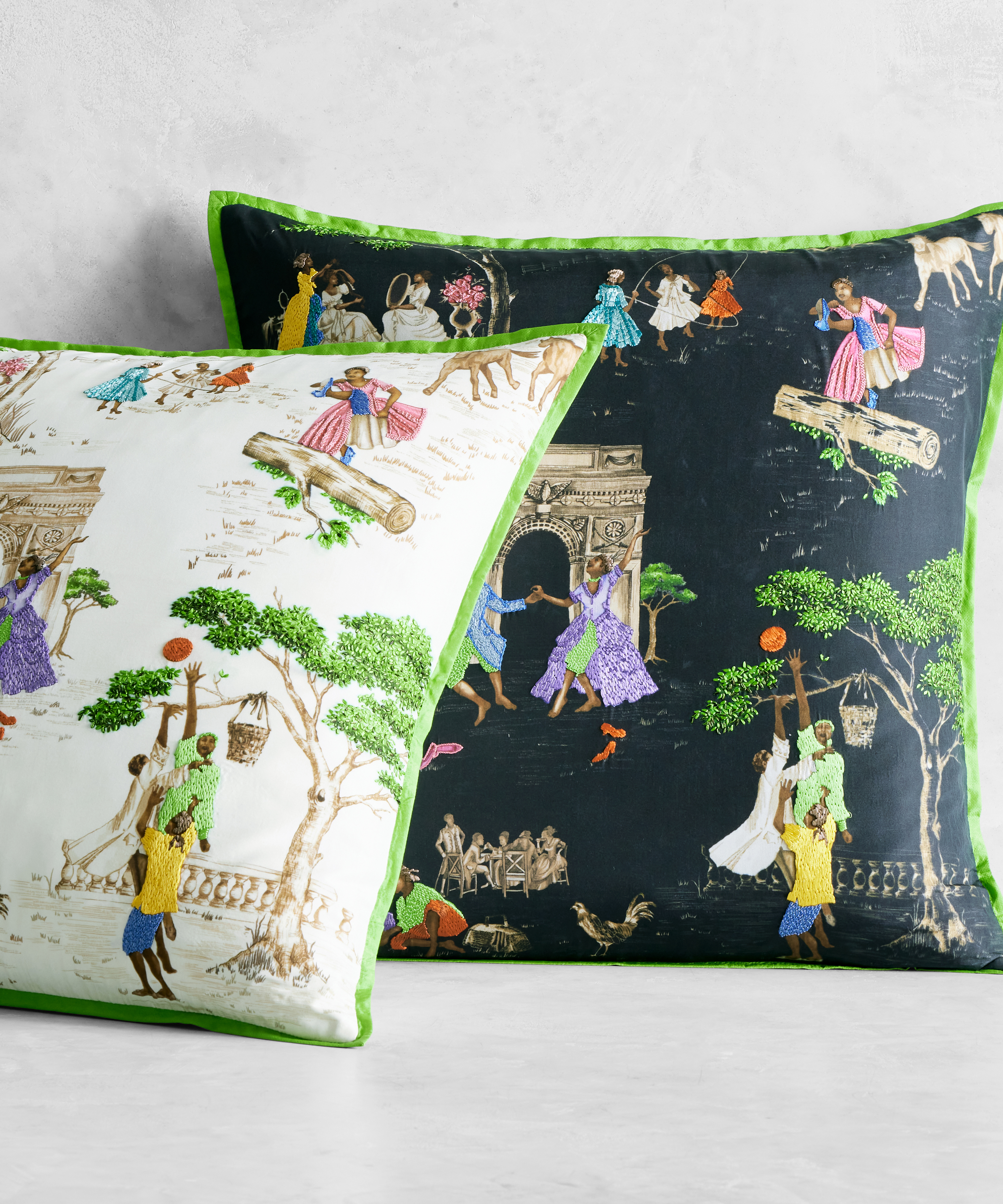 two pillows in Sheila Bridges' Harlem Toile, propped against a white wall