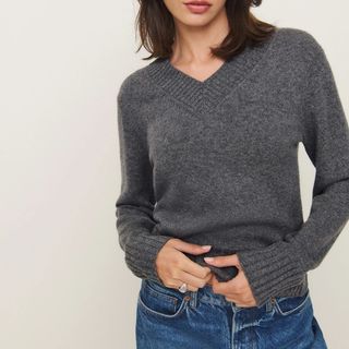 Flat lay image of woman wearing grey jumper