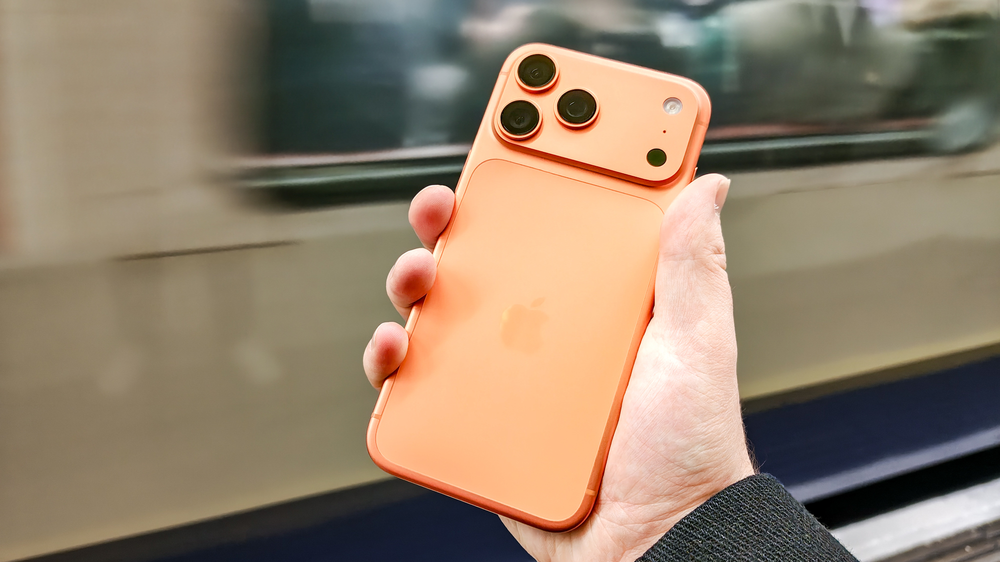 iPhone 17 Pro Max in front of a moving London Underground train