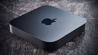 A Mac Mini on a grey stone floor