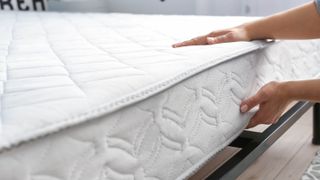 A person turns over a mattress