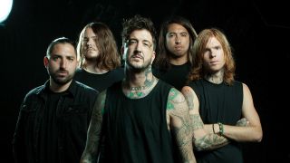A photo shoot with Of Mice And Men on a black background in 2016