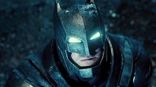 A power-suited up Batman looks up into the sky in 2016's Batman vs Superman