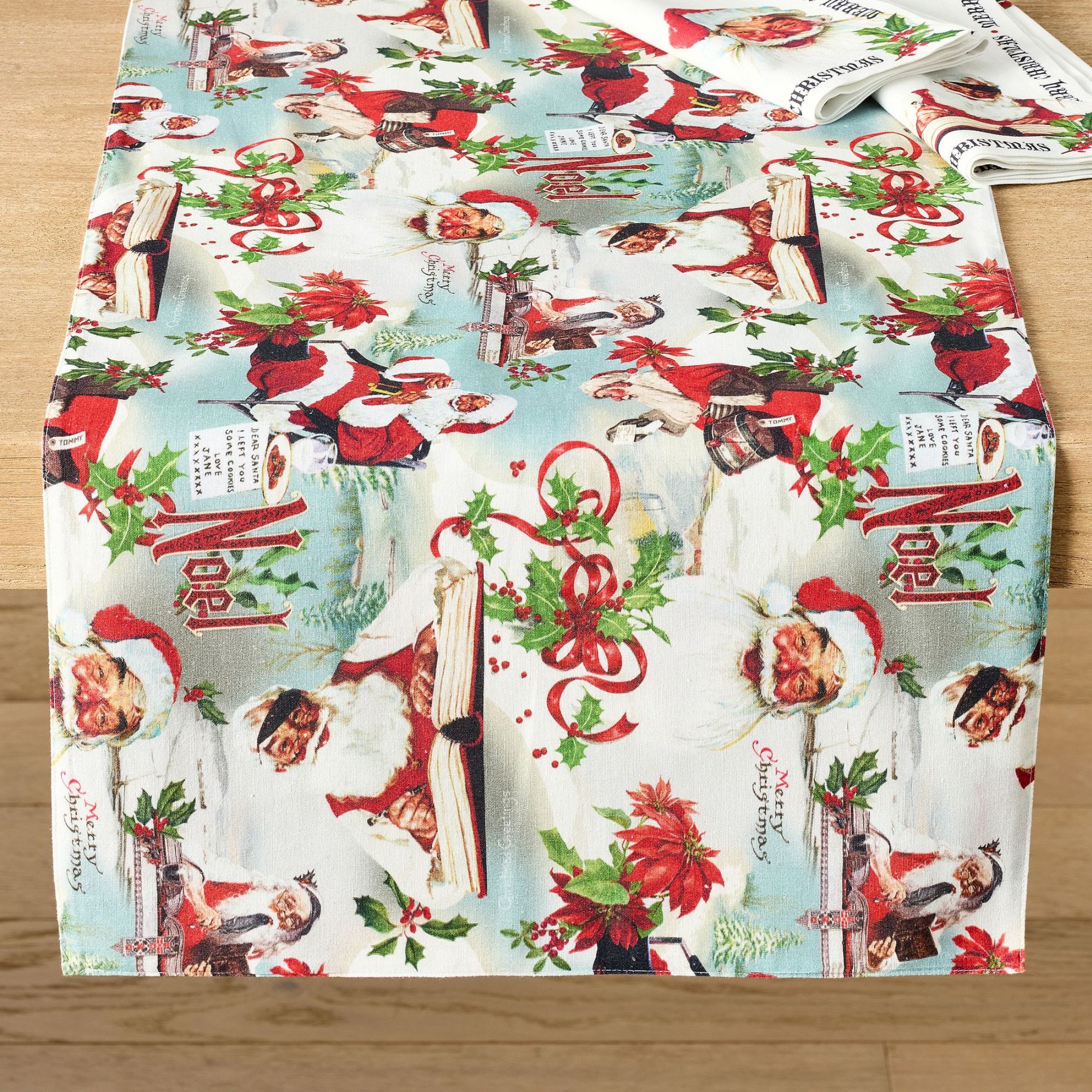 Table runner with Norman Rockwell santa motifs and Christmas slogans