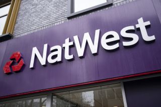 A NatWest sign on the side of a bank branch