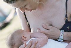 Marie Claire Health News: Woman Breast Feeding a Child