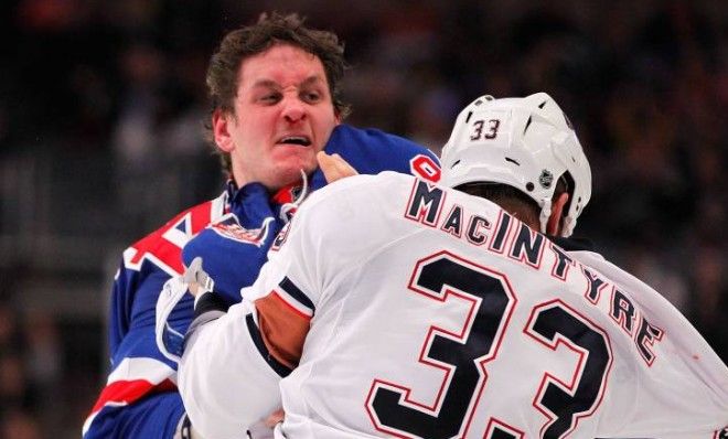 Derek Boogaard, left, committed suicide in 2011 after years of brutal head injuries.