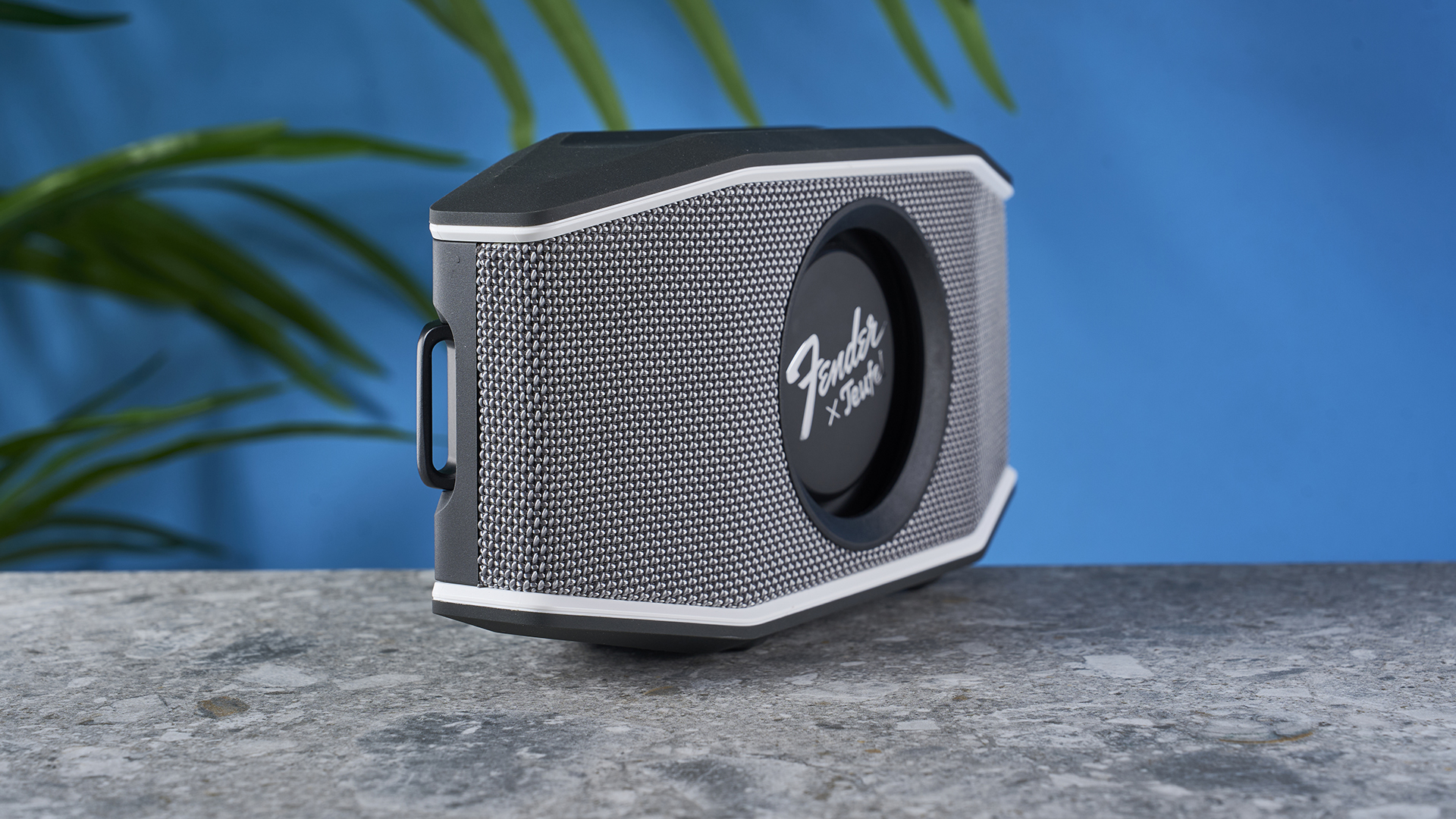 a retro-inspired bluetooth speaker 8 inches long and 4 inches tall with a circular woofer in the center branded with Fender and Teufel