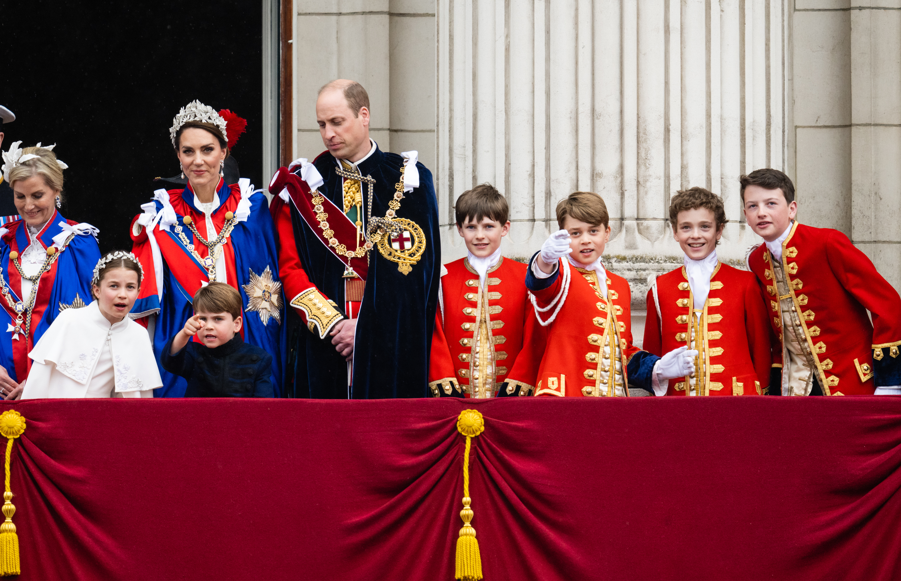 Princess Kate, Prince William, Princess Charlotte, Prince Louis, Prince George and coronation pages on the balcony at Buckingham Palace