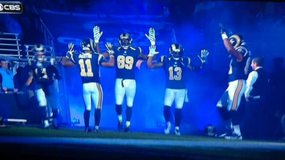 St. Louis Rams raise arms in solidarity with Ferguson protesters before game