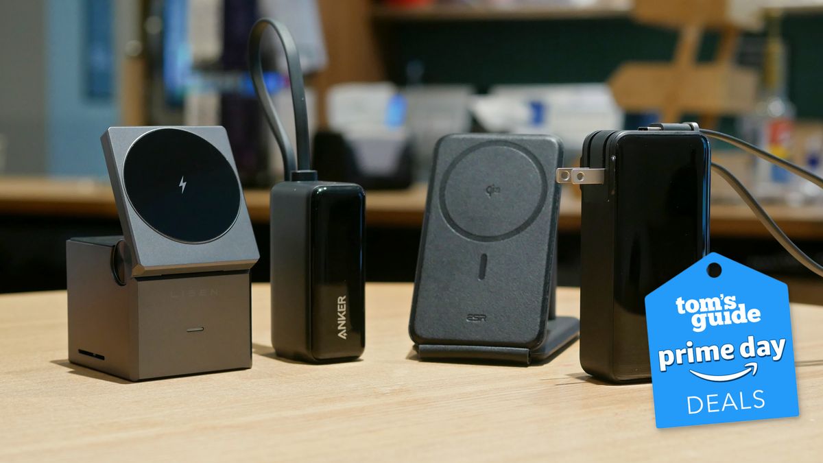 A bunch of portable chargers near one another on a desk.