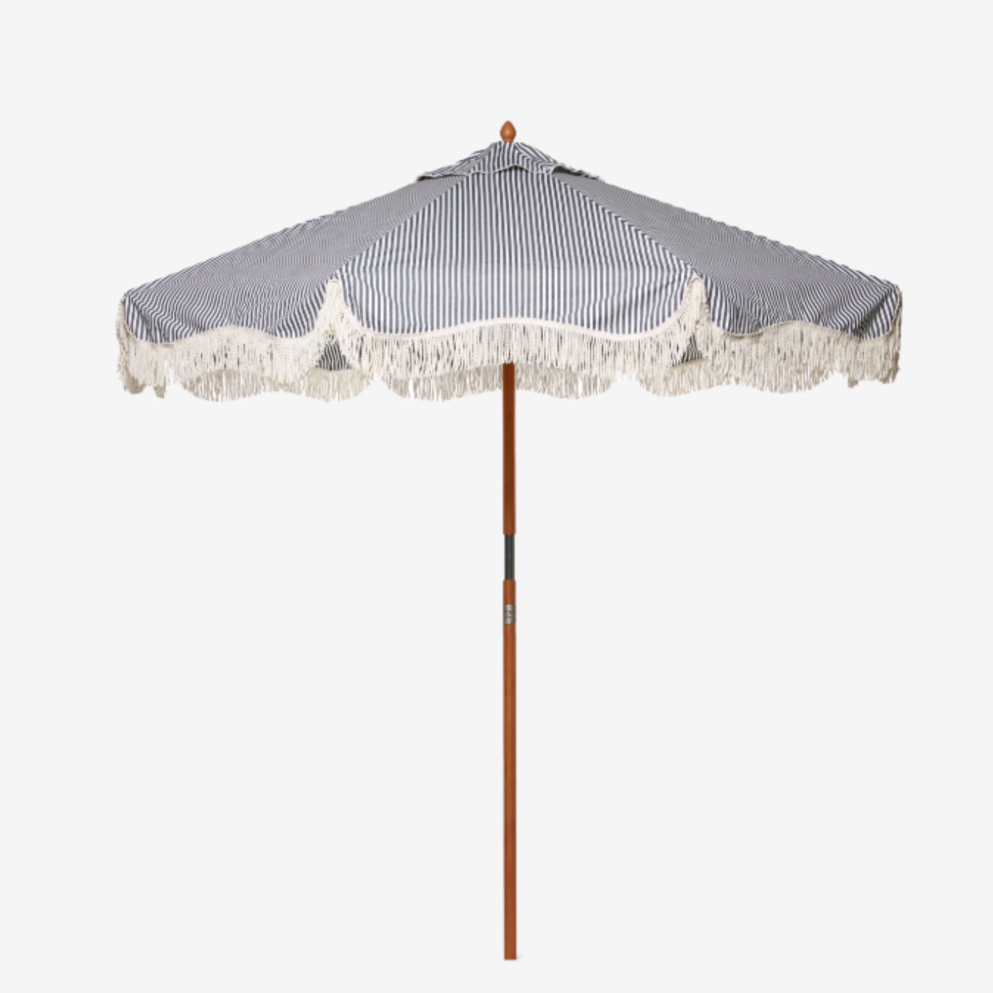 Blue and white striped patio umbrella with fringing