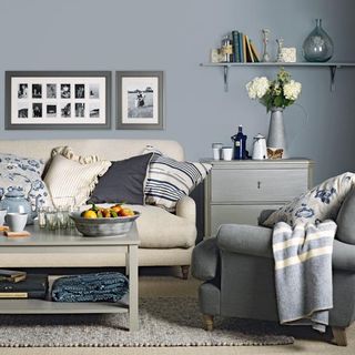 living room with grey wall and stripe blanket