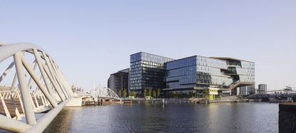 hero exterior of glass shape of booking.com campus by unstudio