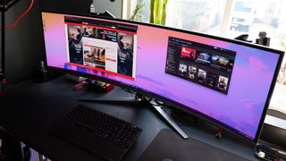 The Asus ROG Swift OLED PG49WCD set up on a gaming desk.