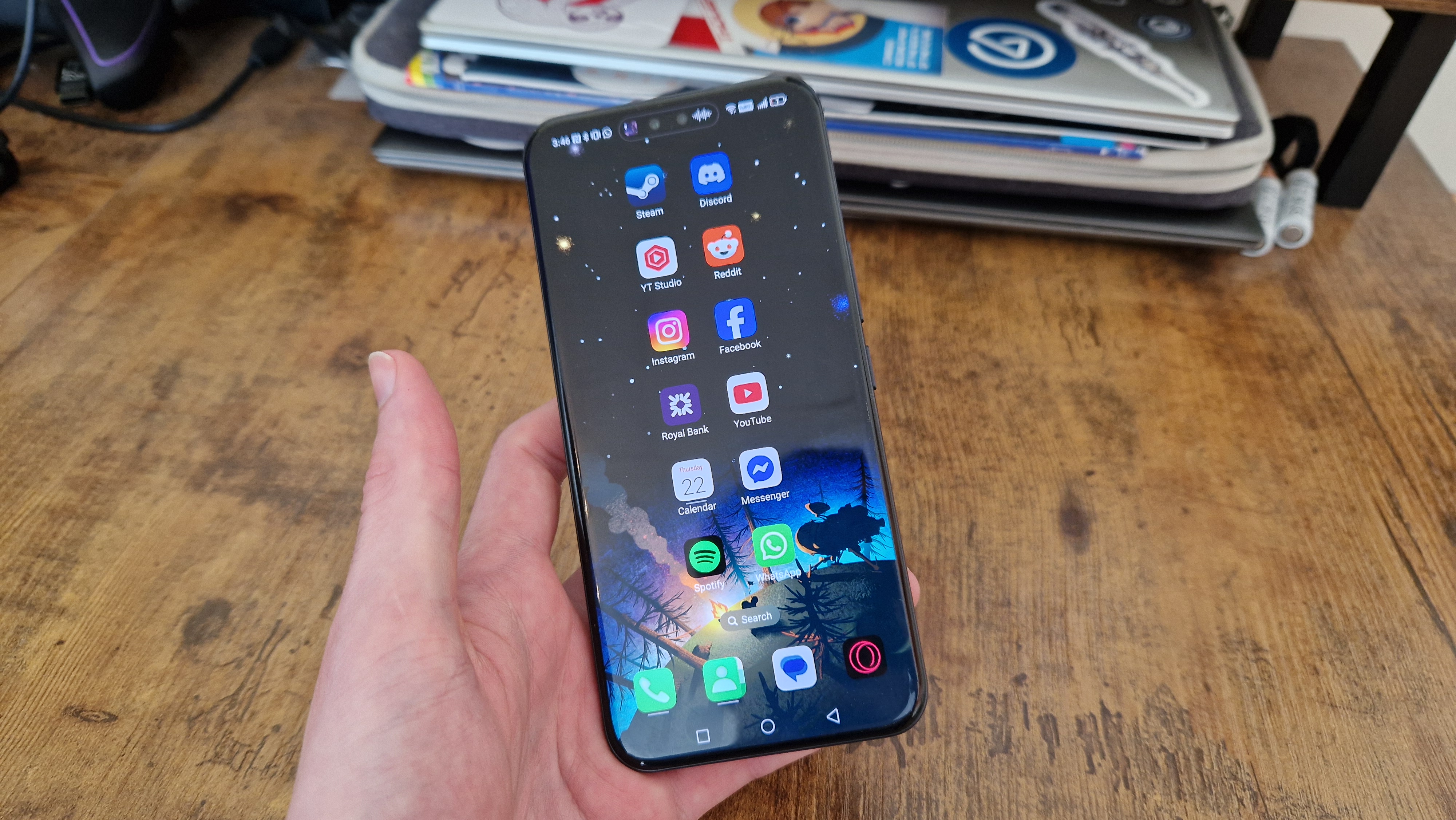 A reviewer holding the Honor 400 Pro