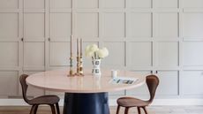 a dining room with panelled walls with hidden storage