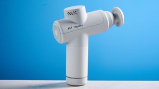 the hyperice hypervolt go 2 massage gun in white/gray with a bullet head attachment, flat head attachment, and a usb-c charging port