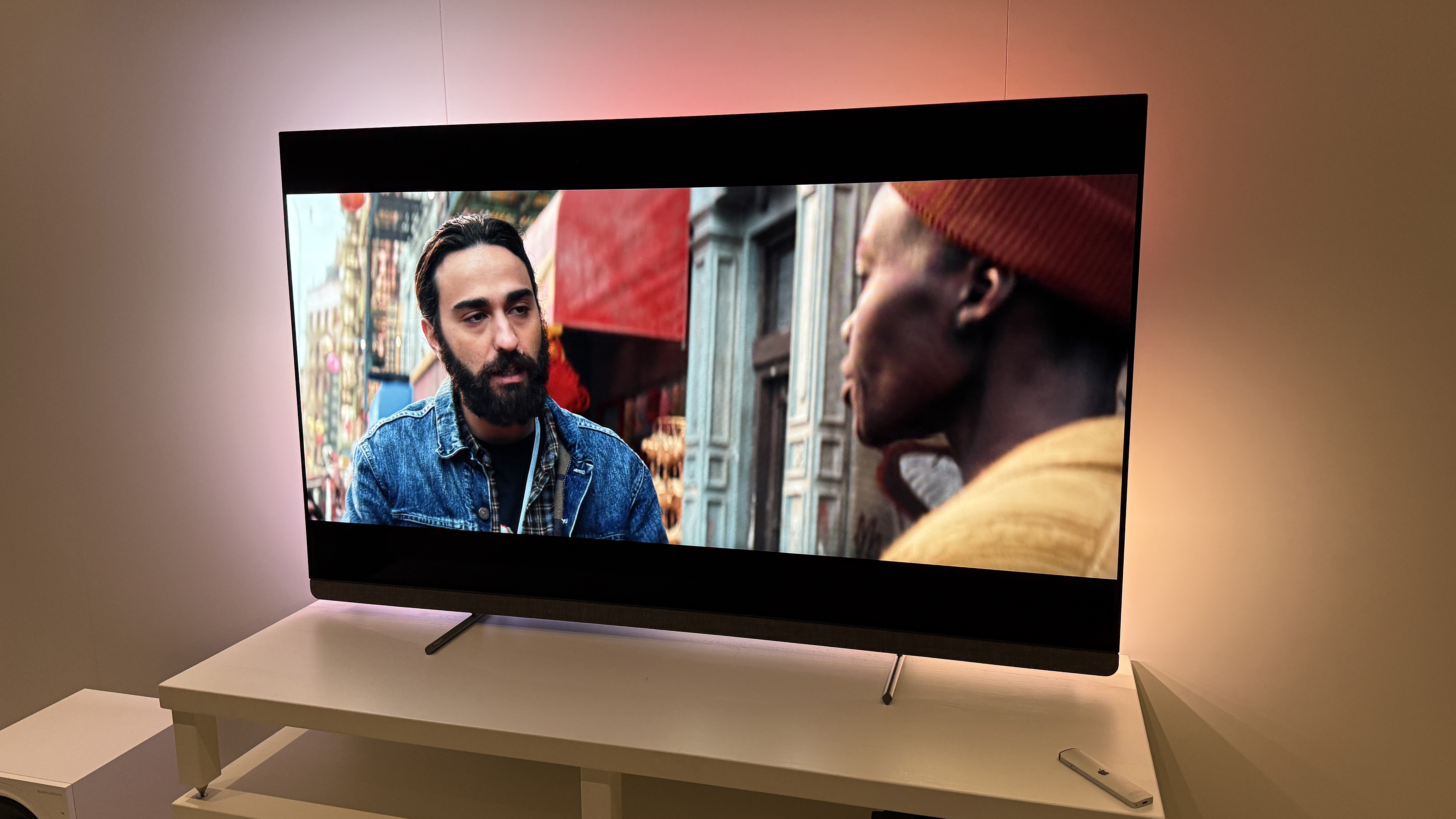 The Philips OLED+910 TV with an image of A Quiet Place: Day One on the screen