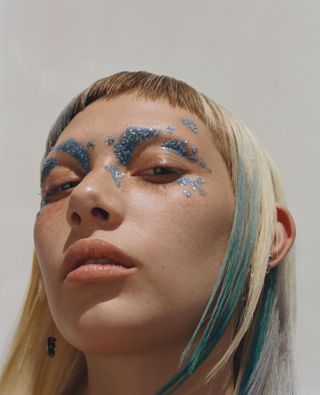 woman wearing submission biodegradable glitter in blue