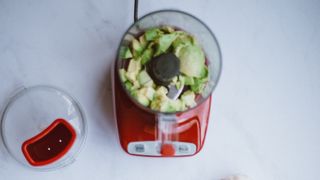 Open blender with chopped veggies