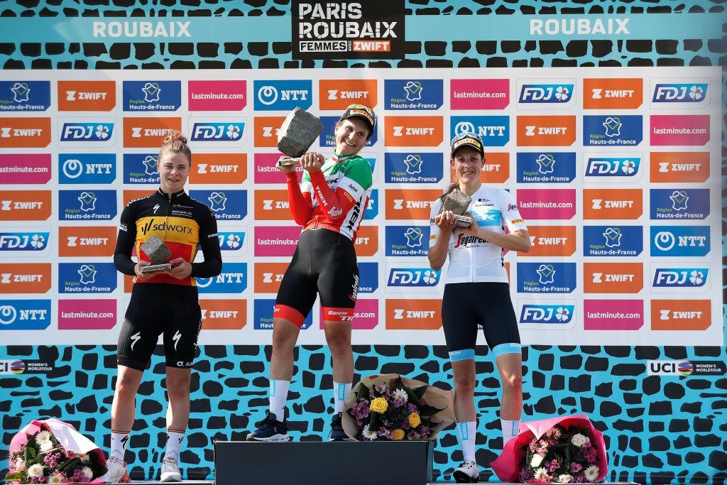 ROUBAIX FRANCE APRIL 16 LR Lotte Kopecky of Belgium and Team SD Worx on second place race winner Elisa Longo Borghini of Italy and Team Trek Segafredo holds up her Cobbleston trophy and Lucinda Brand of Netherlands and Team Trek Segafredo on third place pose on the podium during the podium ceremony after the 2nd ParisRoubaix 2022 Womens Elite a 1247km one day race from Denain to Roubaix ParisRoubaixFemmes ParisRoubaix on April 16 2022 in Roubaix France Photo by Bas CzerwinskiGetty Images