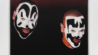 Painting of two men's faces in black and white clown make-up