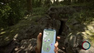 Sons of the Forest keycard location - player stands outside a cave marked on the GPS