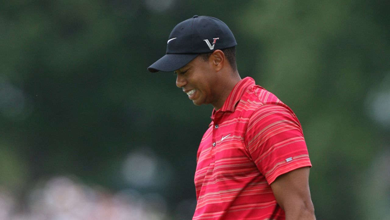 Tiger Woods reacts to missing a putt