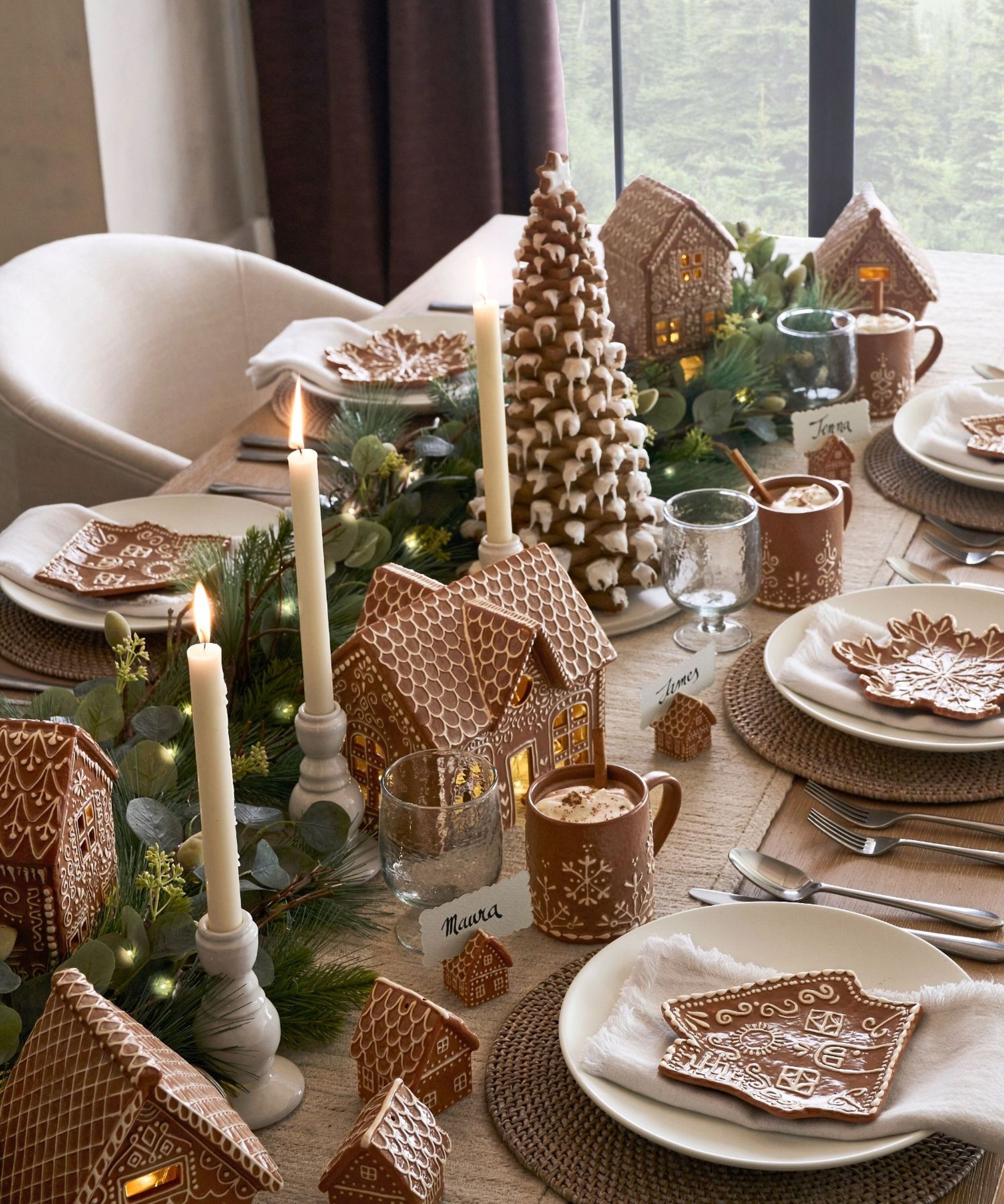 Christmas table with lit garland and gingerbread-themed tableware