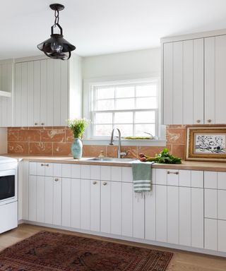 white paneled country kitchen with sink - Shannon Eddings