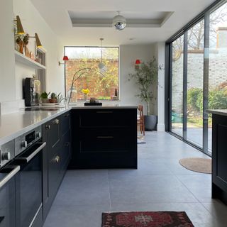 A black open-plan kitchen with a disco ball