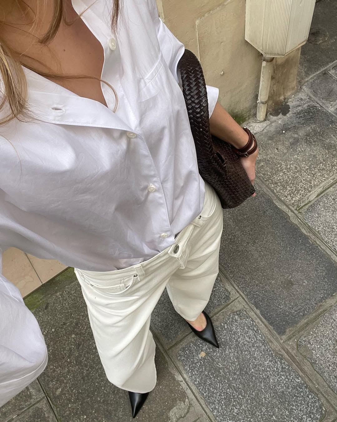 Clara in cream-coloured jeans and white shirt