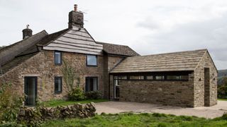 stone-clad single-storey extension in a rural location built from structural insulated panels