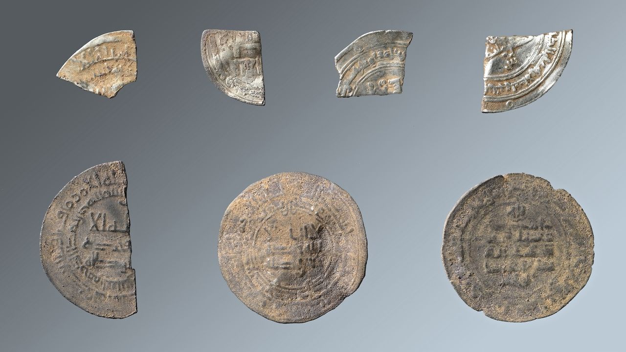 a collection of metal decorated coins and coin fragments