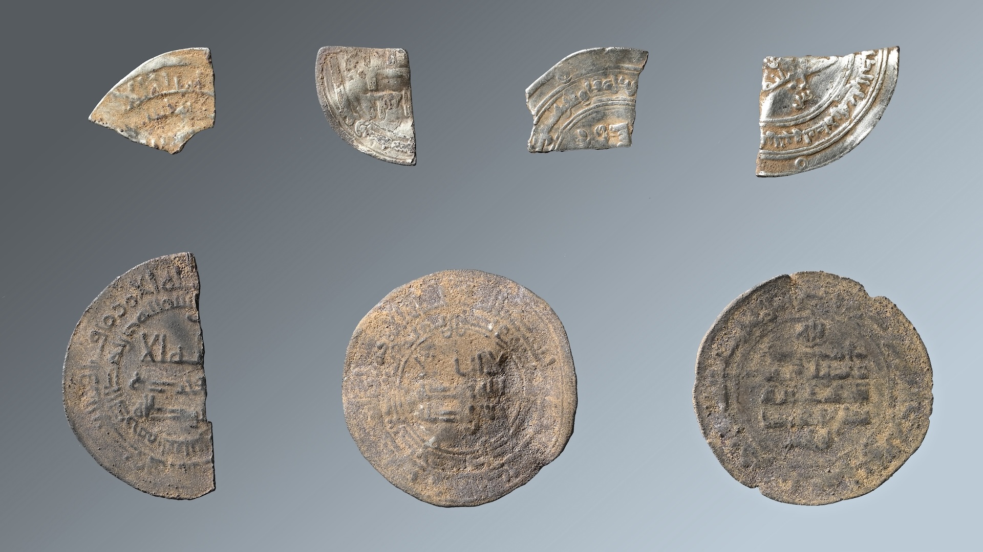 a collection of metal decorated coins and coin fragments