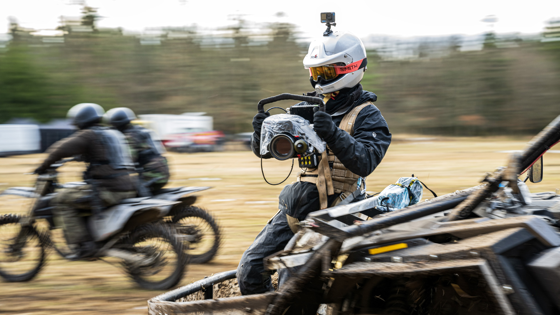 A behind the scenes shot of director Same Hargrave filming a bike chase for Netflix's Extraction 2